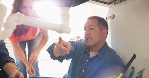 male plumber talking to house owner