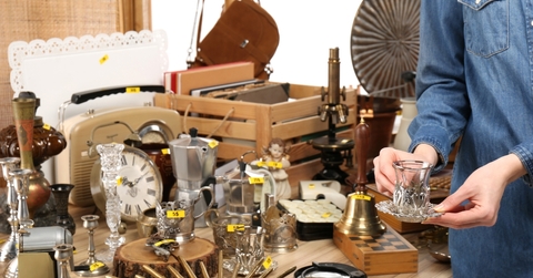 woman buying glassware at garage sale