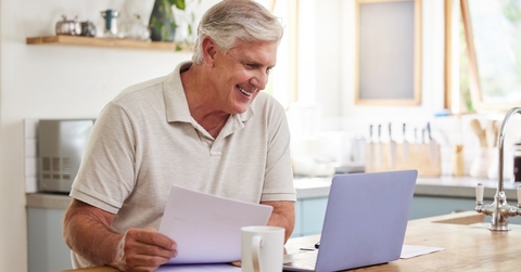 happy senior male investor reading email