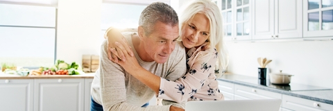 senior couple using laptop