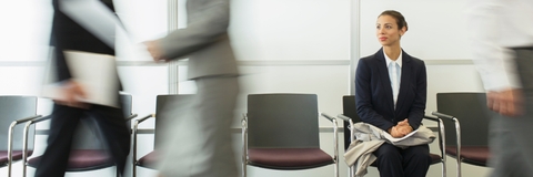 businesswoman sitting in busy waiting area