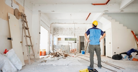 male worker inspecting house renovation