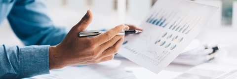 Businessman analyzing graphs at work