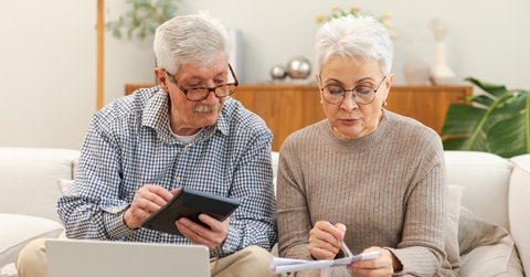 senior couple reviweing budget together