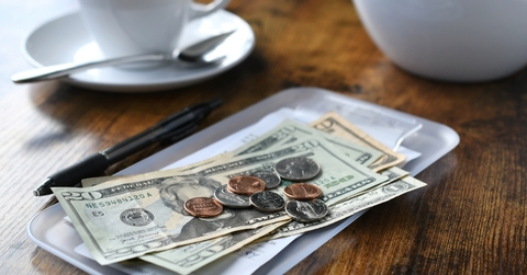 bill tab at cafe with cash money