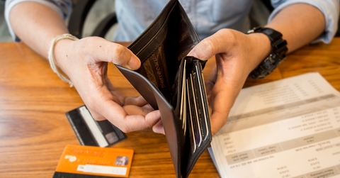 man showing empty wallet debt concept