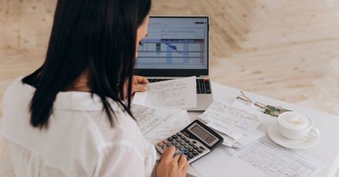 woman calculates utility expenses 