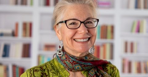 graceful senior woman smiling at library