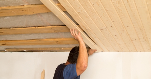 worker working on a wooden ceiling