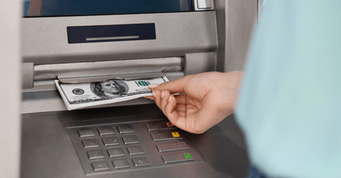 woman getting money from ATM
