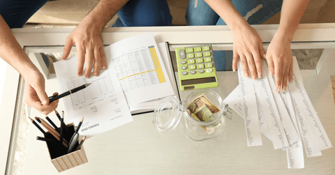 Couple calculating expenses and paying bills