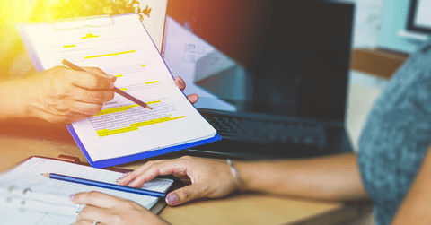 Legal team checking the fine print on business contract to analyze terms and conditions and sign