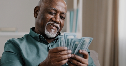 happy african american man counting money