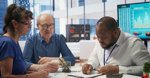 senior citizens consulting a broker