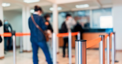 row of people to the bank teller