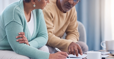 senior couple signing a contract