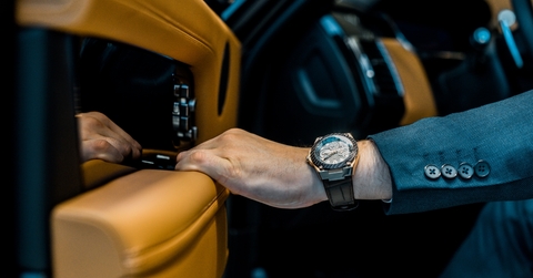 businessman coming out of luxury car