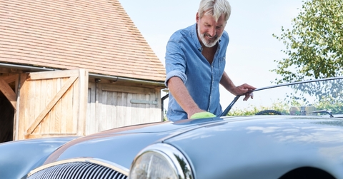 Mature Man Polishing Restored Classic Car Outdoors