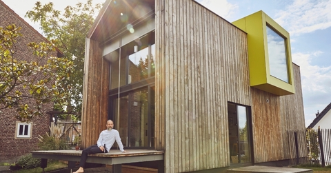 senior man with beer sitting outside house