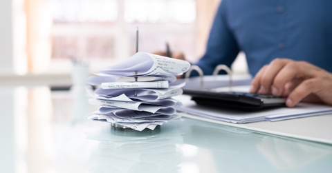 businessman calculating invoice