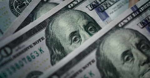 Several one hundred dollar bills at table