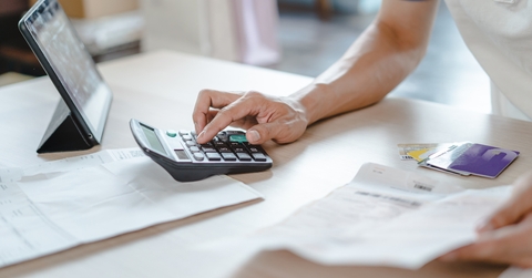 Close up person calculating expenses