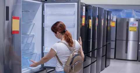 Woman chooses a refrigerator