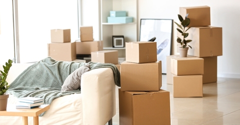 Furniture and moving boxes in room