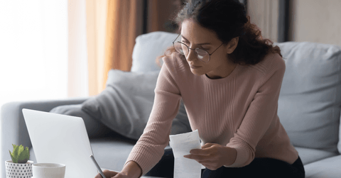 Young woman working on bills