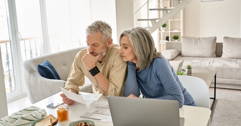 Retired couple reviewing bills together at home 