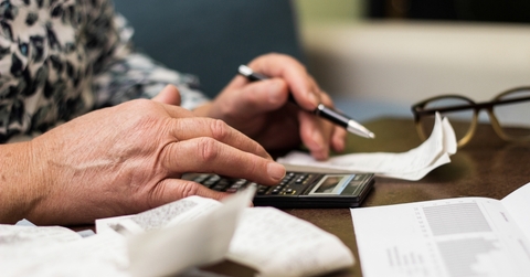 Senior woman checking bills at home