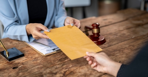 lawyer delivering legal documents in envelope