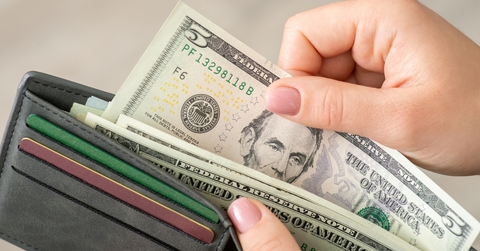 woman gets american money from the wallet