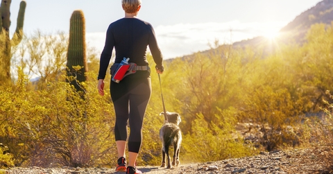 woman hiking with dog