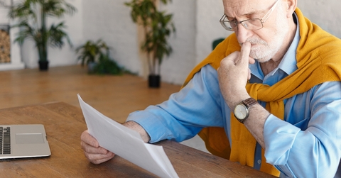 senior male studying paper works