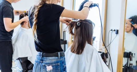 woman drying hair in hair salon 