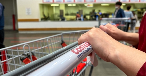 hands pushing a costco carton