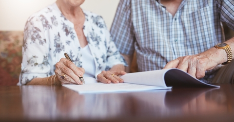 Senior woman signing documents