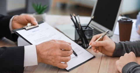 man signing documents