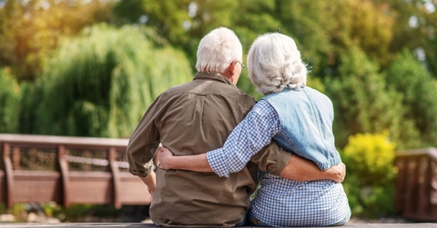 Mature couple resting near lake