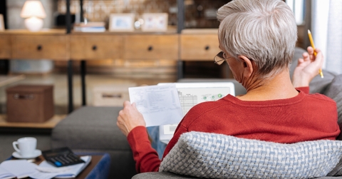 lying on the sofa and reading documents