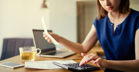 woman using laptop and calculator
