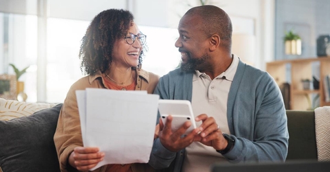 happy man and woman with paperwork budget and retirement fund with investment