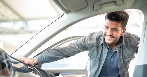 Man taking taking look at car in showroom