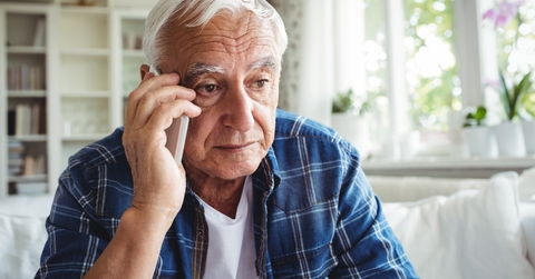 tensed senior man talking on mobile phone 