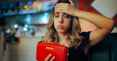 Unhappy Restaurant Client Checking her Empty Wallet