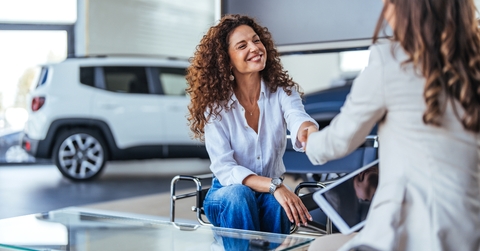 Happy woman buying a car