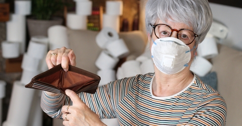 senior woman holding empty wallet