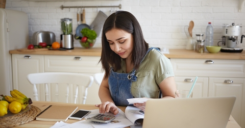 woman doing calculations managing home budget