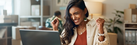 Triumphant woman looking at computer
